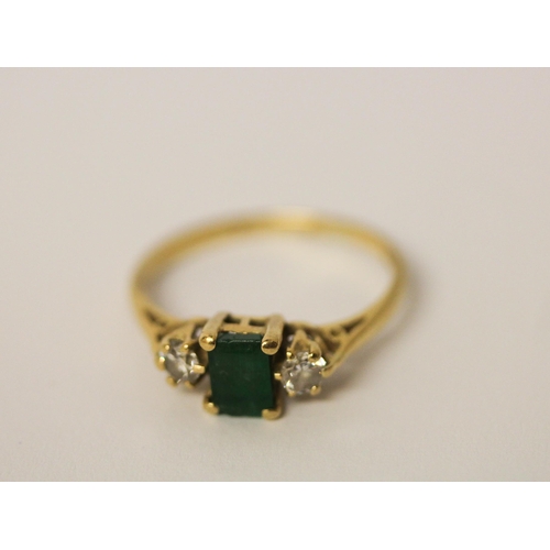 538 - A three stone emerald and diamond ring, on hallmarked 18ct yellow gold band, ring size N, weight 2.5... 