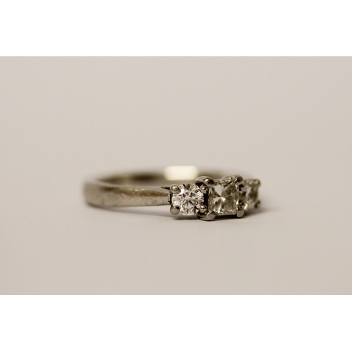 554 - A platinum and diamond three stone ring, hallmarked, ring size K, weight 4.6g