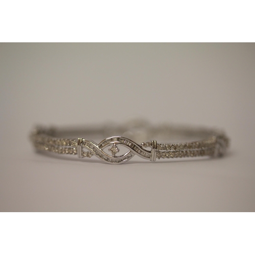 567 - Modern diamond bangle, set with brilliant and baguette cut diamonds, estimated to weigh 2.6-3 carat ... 