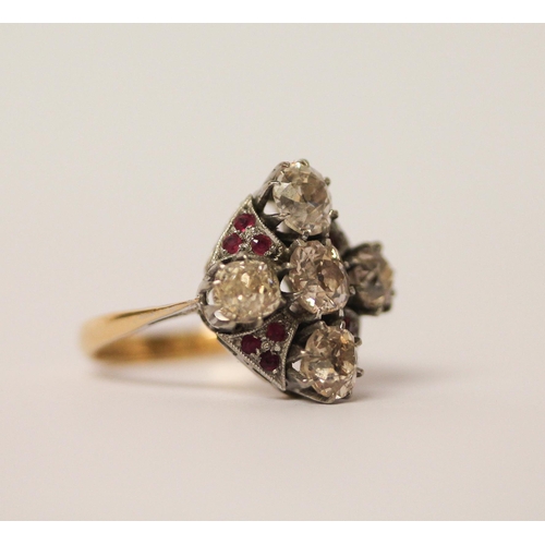 568 - An Art Deco ring, set with five old cut diamonds in a quatrefoil motif with small rubies between, in... 