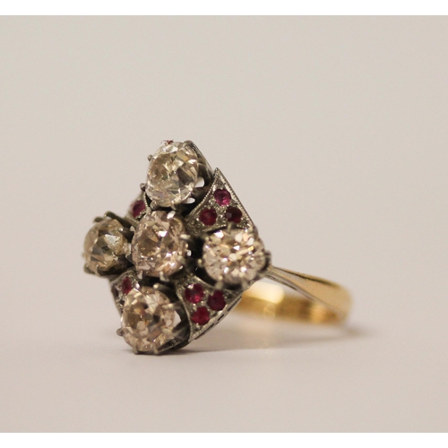 568 - An Art Deco ring, set with five old cut diamonds in a quatrefoil motif with small rubies between, in... 