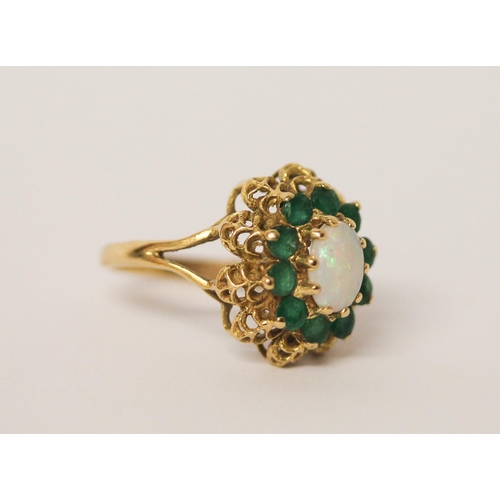 570 - An opal and emerald oval cluster ring, on 18ct yellow gold, ring size O, weight 5.4 grams