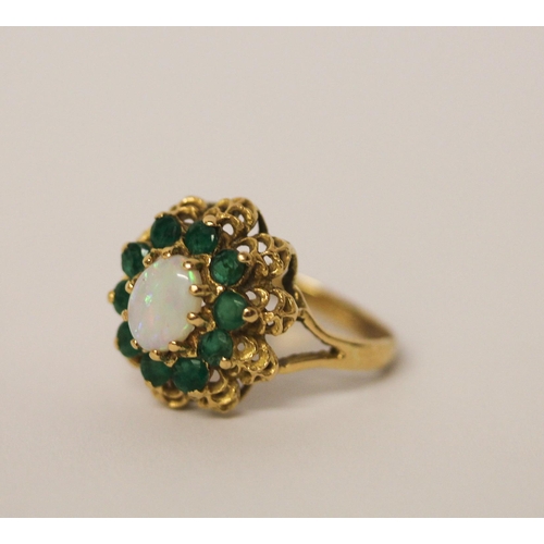 570 - An opal and emerald oval cluster ring, on 18ct yellow gold, ring size O, weight 5.4 grams