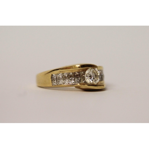 573 - An 18ct yellow gold diamond dress ring, with a central brilliant cut diamond on pave shoulders. Ring... 