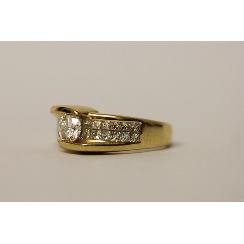 573 - An 18ct yellow gold diamond dress ring, with a central brilliant cut diamond on pave shoulders. Ring... 