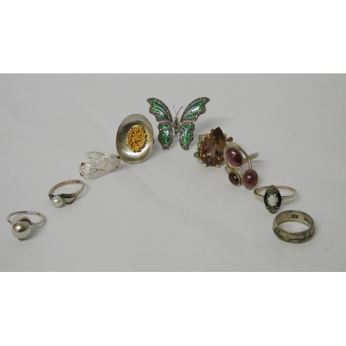 648 - A collection of silver dress rings to include large enamel butterfly example