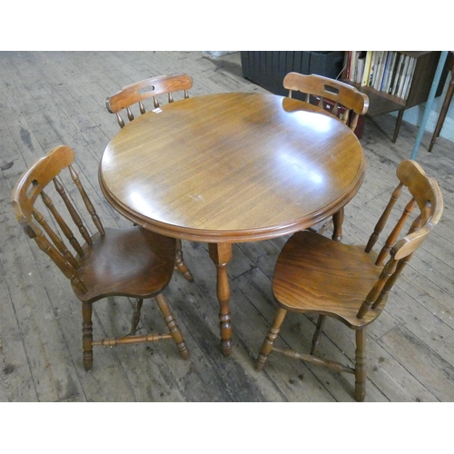 174 - A circular dining table and a set of four spindle back Windsor style chairs to match