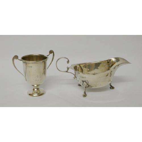 733 - A silver sauce boat and a small silver twin handled trophy cup, 4.7 troy ounces