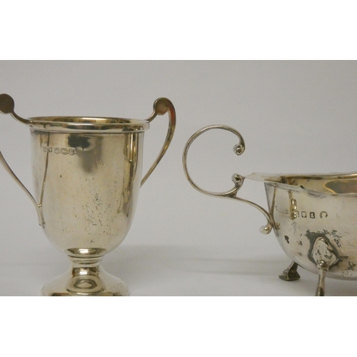 733 - A silver sauce boat and a small silver twin handled trophy cup, 4.7 troy ounces