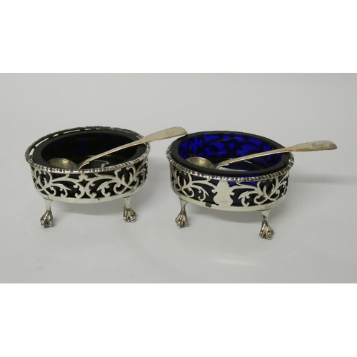 736 - A pair of Georgian silver salt cellars, of pierced oval form with blue glass liners, and two silver ... 