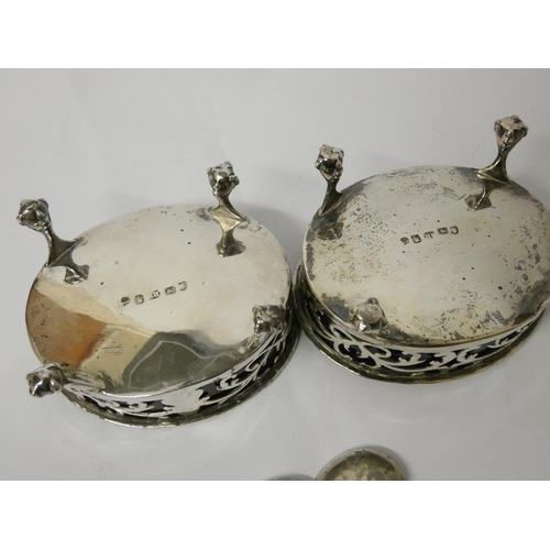 736 - A pair of Georgian silver salt cellars, of pierced oval form with blue glass liners, and two silver ... 