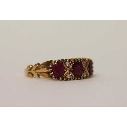 742 - A three stone ruby ring, in a Victorian style setting with small diamonds, hallmarked 18ct yellow go... 