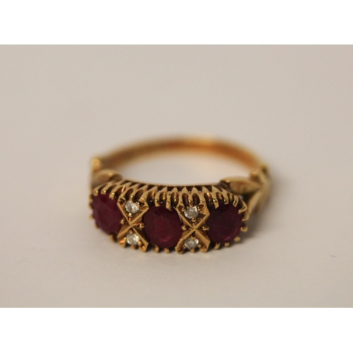 742 - A three stone ruby ring, in a Victorian style setting with small diamonds, hallmarked 18ct yellow go... 