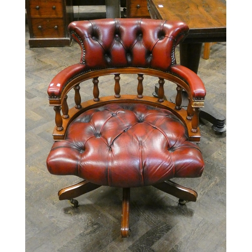 203 - A buttoned red leather captains style desk chair