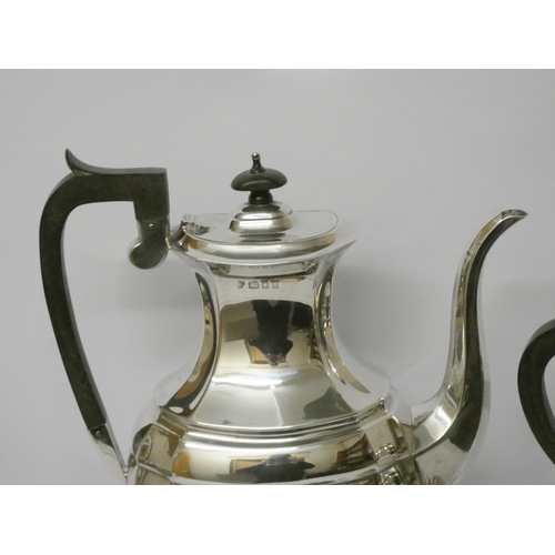 735 - A four piece hallmarked silver tea and coffee service, with ebony handles, hallmarked London 1957, g... 