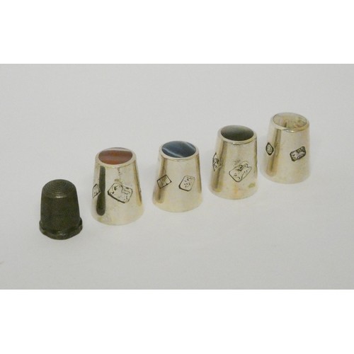 624A - Four modern silver thimbles with semi precious stones inset to the tops and an earlier silver thimbl... 