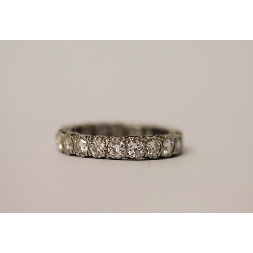 764 - A diamond eternity ring set with 18 brilliant cut diamonds, plain section to back of band, in platin... 