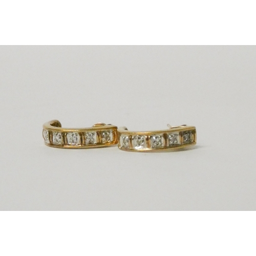 766 - A pair of 9ct yellow gold diamond set half hoop earrings.