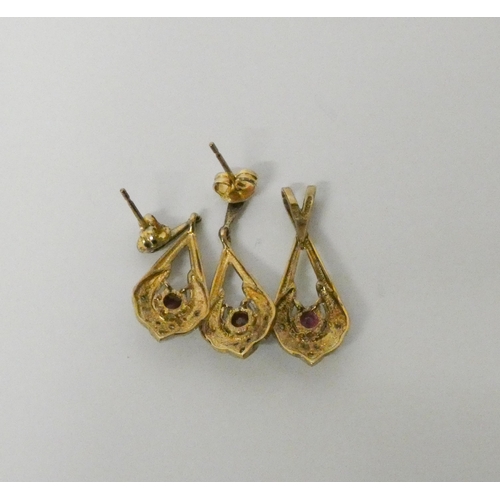 769 - A modern ruby and diamond pendant with matching drop earrings, in 9ct yellow gold