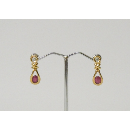 771 - A pair of modern 9ct gold ruby and diamond drop earrings, posts hallmarked.