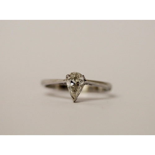 773 - A modern solitaire diamond ring, the pear shaped brilliant cut diamond of E colour, 0.83 carats, las... 