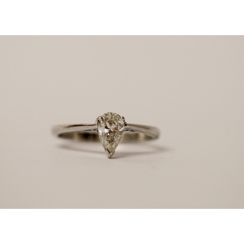 773 - A modern solitaire diamond ring, the pear shaped brilliant cut diamond of E colour, 0.83 carats, las... 