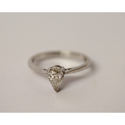 773 - A modern solitaire diamond ring, the pear shaped brilliant cut diamond of E colour, 0.83 carats, las... 