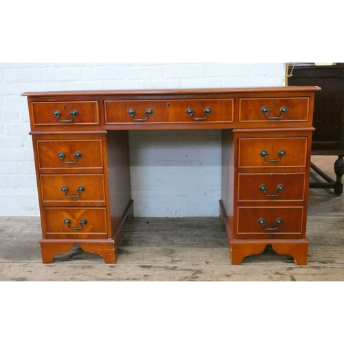 40 - A Georgian style twin pedestal office desk fitted nine drawers with green inset leather top, 4' wide