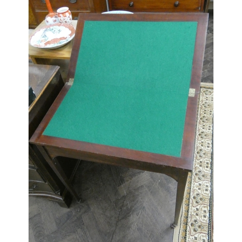 106 - An Edwardian star inlaid mahogany fold over top card table with green baize lining