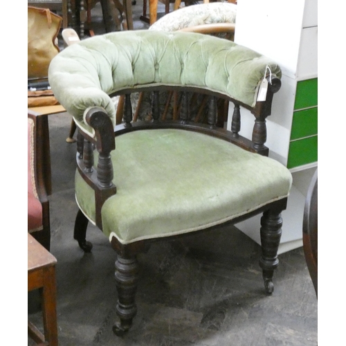 109 - A Victorian spindle back comb shaped buttoned easy chair in green velvet