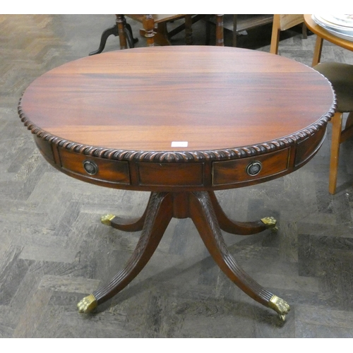 114 - An oval Georgian style drum style table with pie crust edge standing on a quadruple base