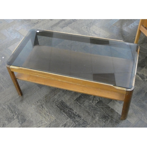 118 - A smoked glass two tiered teak coffee table and three dining chairs