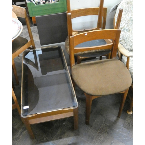 118 - A smoked glass two tiered teak coffee table and three dining chairs