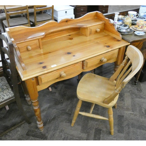 128 - A modern varnished pine panel back desk fitted two drawers and a matching chair