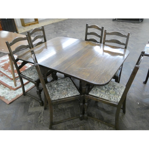 145 - Dark oak gate leg dining table on turned legs together with six matching ladder back dining chairs w... 