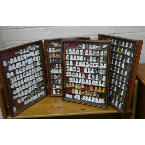 154 - Four modern glazed wall mounting display cases containing a collection of bone china and other thimb... 