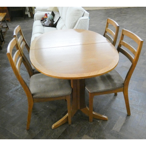 157 - A modern oval teak extending dining table and four matching chairs