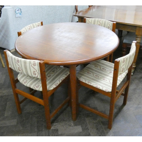 166 - A Danish circular teak extending dining table and four similar chairs with upholstered seats and bac... 