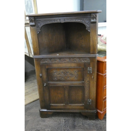 39 - A reproduction carved oak corner cabinet