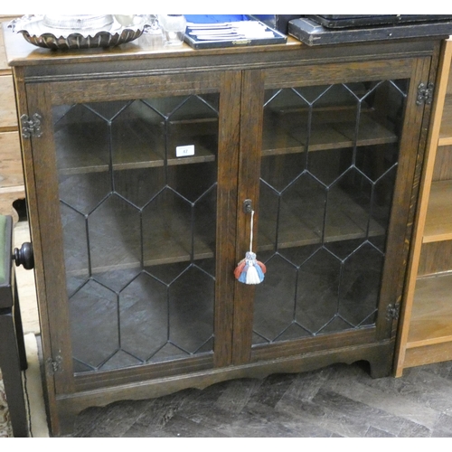 47 - A reproduction oak leaded glazed two door bookcase