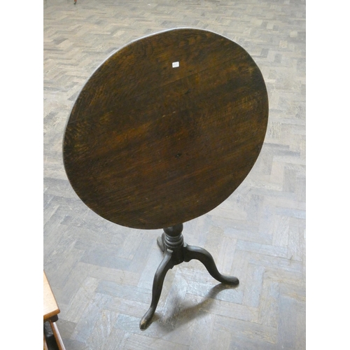 63 - An Antique oak circular snap top tripod table