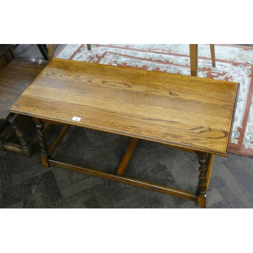 148 - A long oak coffee table on barley twist leg and stretcher base, 42