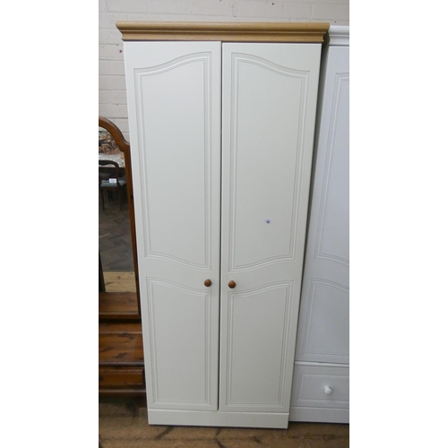 160 - A cream and light oak finished two door wardrobe