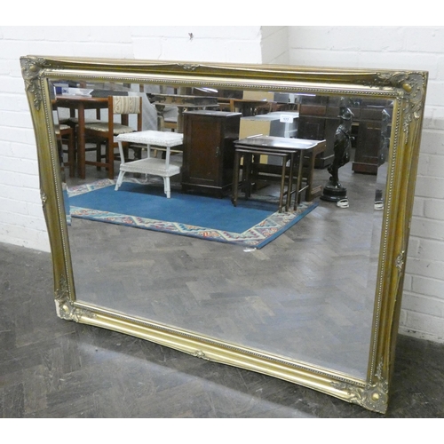 177 - A large bevelled wall mirror in decorative gilt frame, 4'6 x 3'6