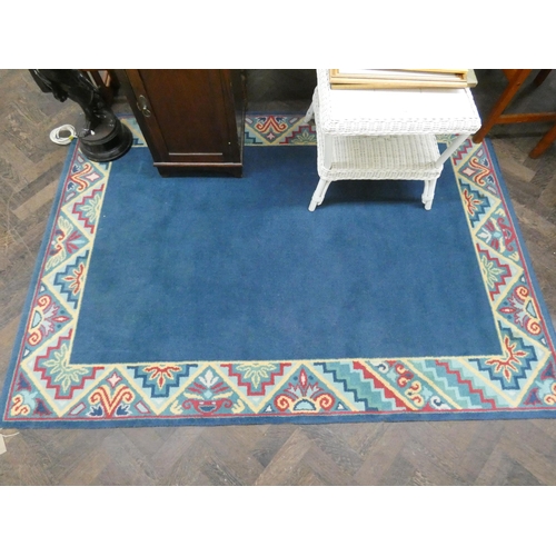 186 - A blue and bordered wool pile rug