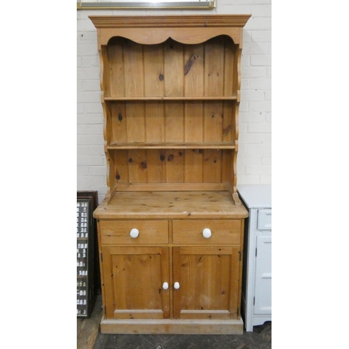 188 - A stripped pine kitchen dresser with shelf back, drawers and cupboards under, 3' wide