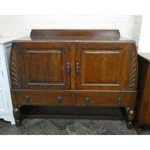 192 - A 1930's oak sideboard with curved ends fitted cupboards and drawers, 4' wide