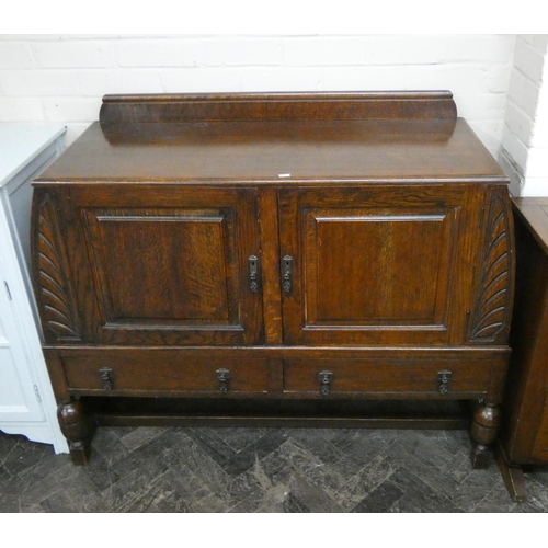 192 - A 1930's oak sideboard with curved ends fitted cupboards and drawers, 4' wide