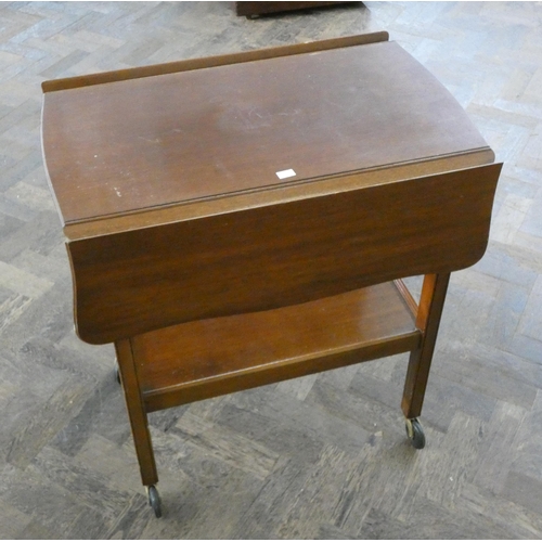 194 - A two tier drop leaf tea trolley together with an oak workbox with assorted cottons etc