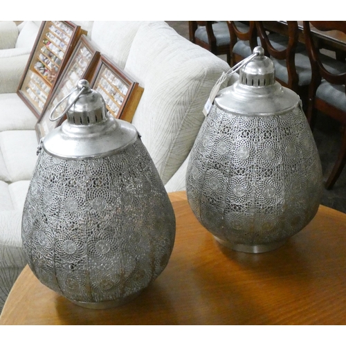 135 - A pair of silver coloured pierced metal hanging candle holders, approximately 18